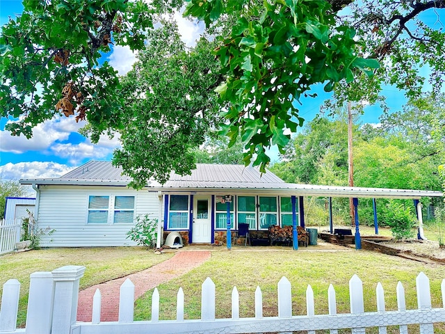 view of front of property with a front yard, covered porch, and a carport