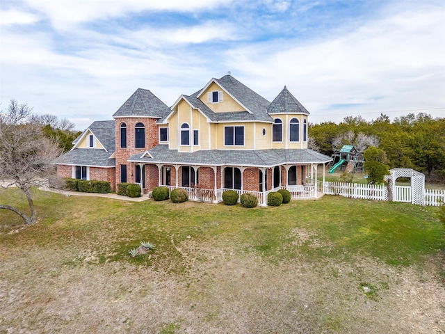 victorian home with a front lawn and covered porch