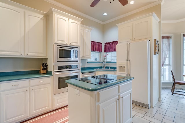 kitchen featuring white cabinetry, sink, appliances with stainless steel finishes, ceiling fan, and crown molding