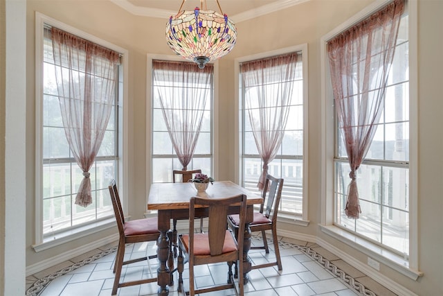 dining space featuring light tile patterned floors, an inviting chandelier, and crown molding