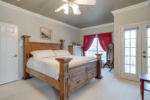 carpeted bedroom with ornamental molding, french doors, and ceiling fan