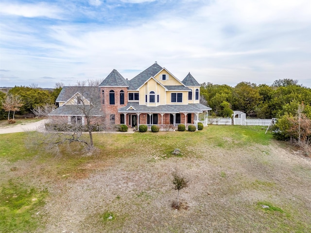 view of front of house featuring a front lawn and covered porch