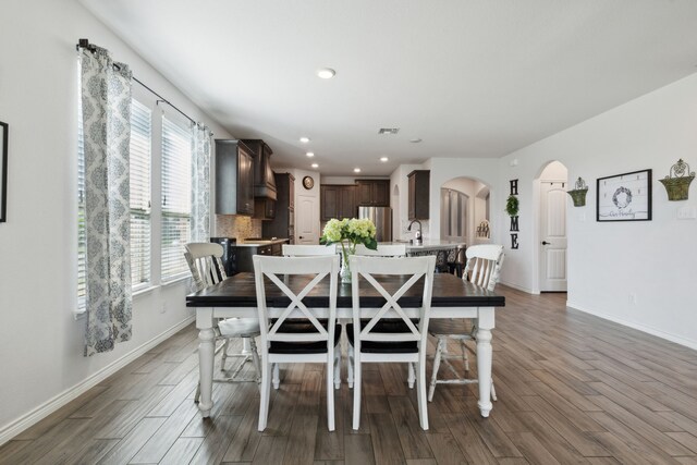 dining room with dark wood-type flooring and sink