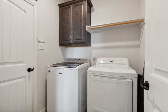 washroom with cabinets and independent washer and dryer