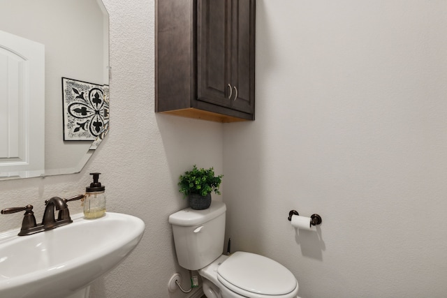 bathroom with toilet and sink