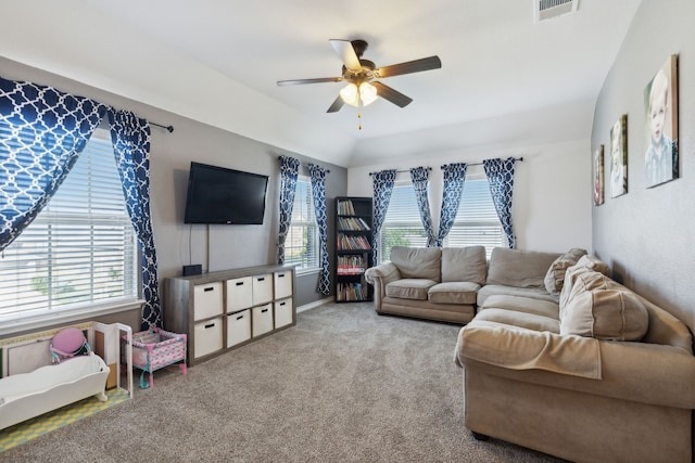 living room featuring plenty of natural light, ceiling fan, vaulted ceiling, and carpet flooring