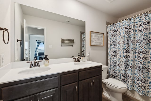 bathroom with vanity, toilet, and a shower with shower curtain