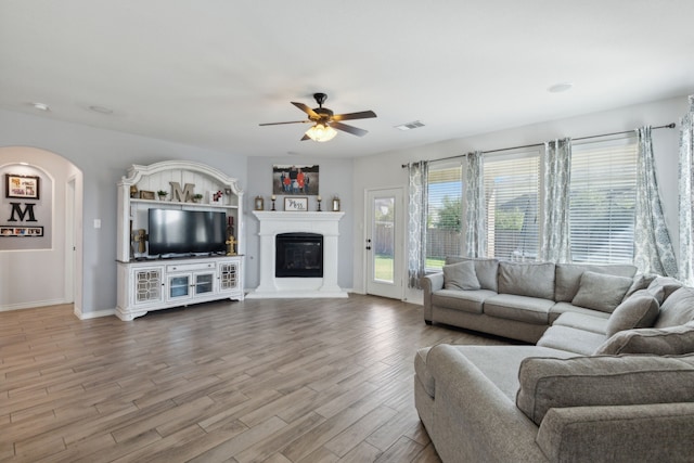 living room featuring wood-type flooring and ceiling fan