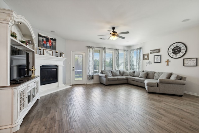 unfurnished living room with dark wood-type flooring and ceiling fan