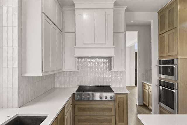 kitchen with white cabinetry, appliances with stainless steel finishes, and tasteful backsplash