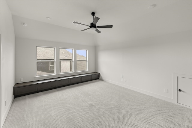 carpeted spare room with a baseboard radiator and ceiling fan