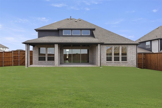 back of property with a patio area and a lawn