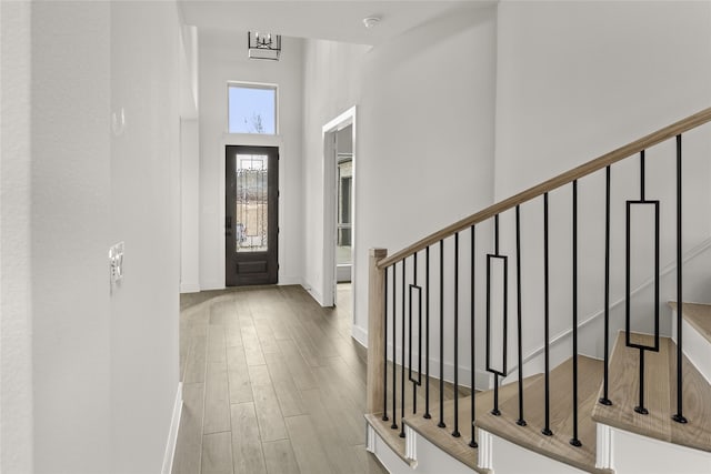 entryway with a high ceiling and light hardwood / wood-style floors