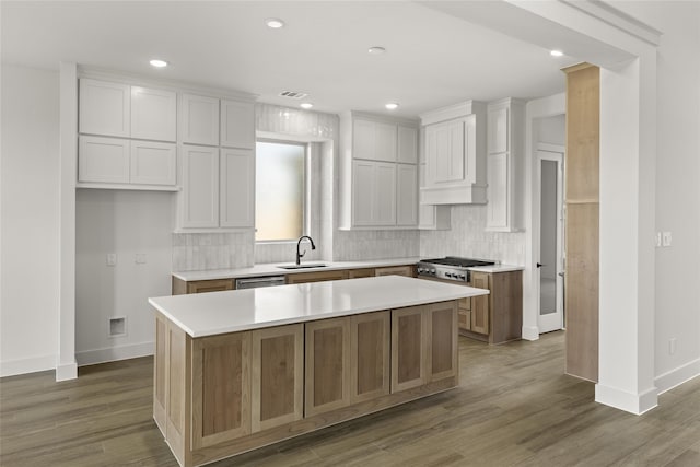 kitchen featuring white cabinets, dark hardwood / wood-style flooring, sink, and a kitchen island