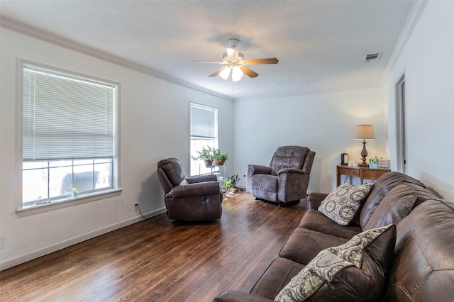 living room with dark wood-type flooring, ceiling fan, crown molding, and a textured ceiling