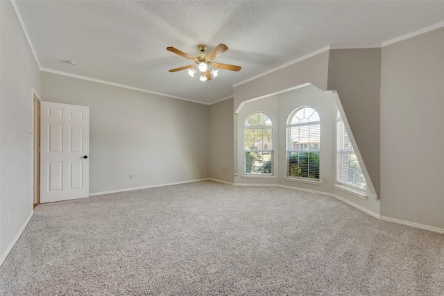 spare room featuring a textured ceiling, crown molding, ceiling fan, and carpet floors