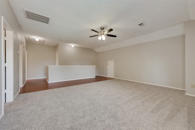 unfurnished room with carpet flooring, ceiling fan, and vaulted ceiling