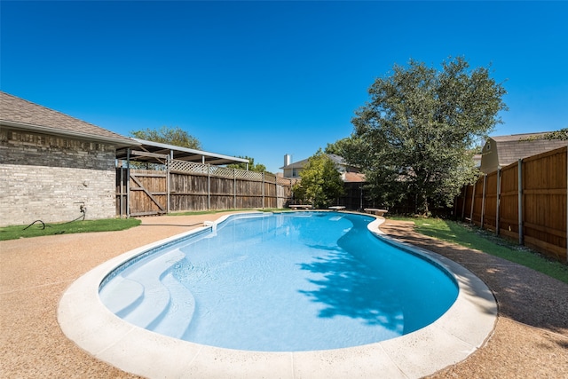 view of swimming pool featuring a diving board