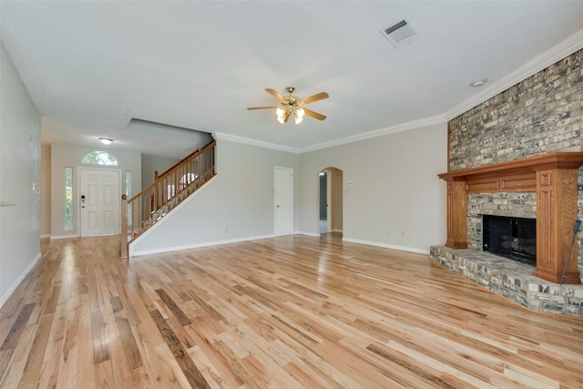 unfurnished living room with light wood-type flooring, crown molding, ceiling fan, and a textured ceiling