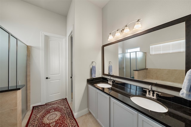 bathroom featuring tile patterned flooring, a washtub, and vanity