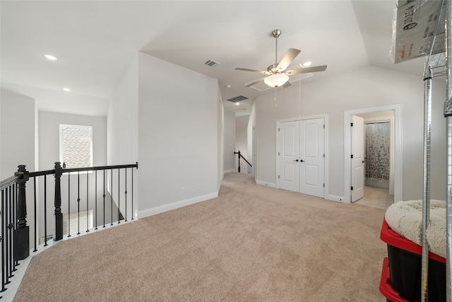 interior space featuring lofted ceiling and ceiling fan