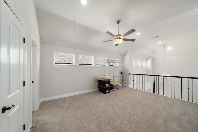 unfurnished room with ceiling fan, light colored carpet, and vaulted ceiling