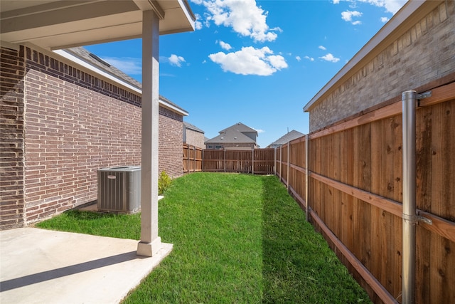 view of yard with a patio and central AC unit