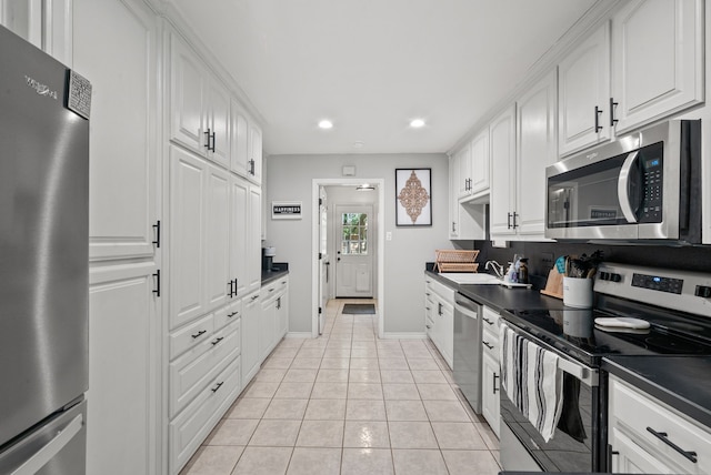 kitchen with light tile patterned floors, white cabinetry, stainless steel appliances, and sink