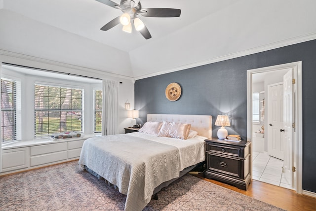 bedroom featuring lofted ceiling, ceiling fan, and light hardwood / wood-style flooring