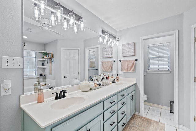 bathroom with tile patterned flooring, toilet, and vanity