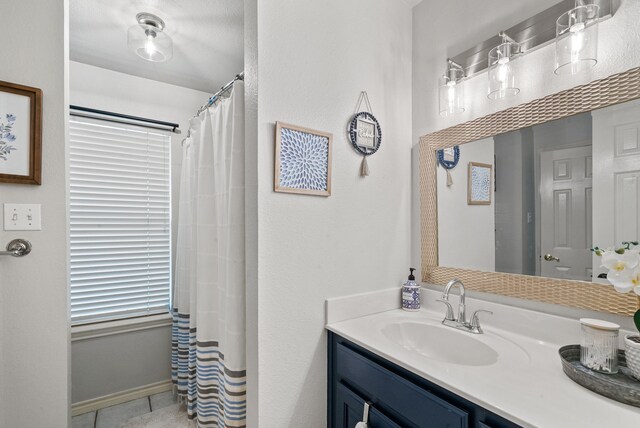 bathroom with vanity, a shower with curtain, and tile patterned floors