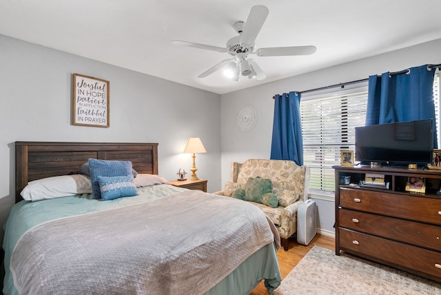 bedroom featuring light hardwood / wood-style flooring and ceiling fan