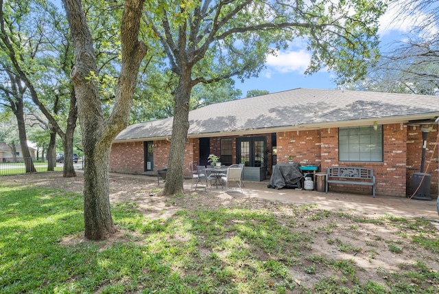 rear view of property with french doors and a patio