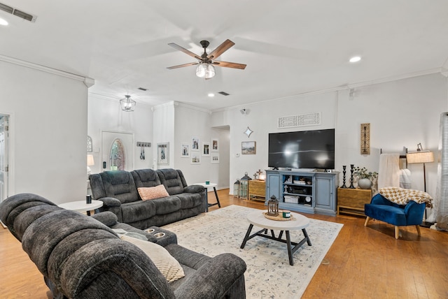 living room with crown molding, hardwood / wood-style floors, and ceiling fan