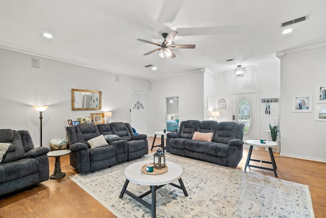 living room featuring crown molding, hardwood / wood-style floors, and ceiling fan