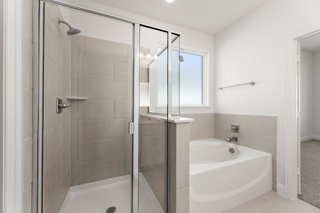 bathroom with plus walk in shower and tile patterned flooring