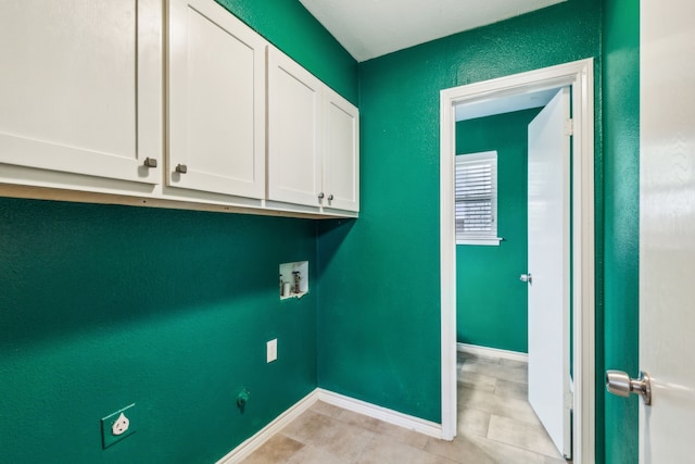 laundry area with washer hookup, cabinets, light tile patterned floors, and electric dryer hookup