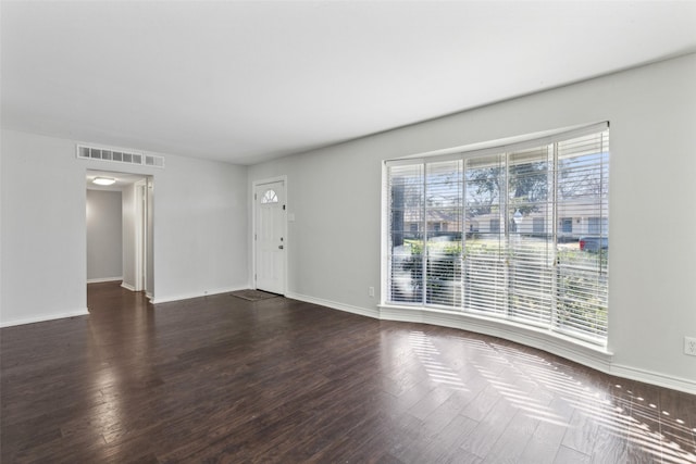 unfurnished living room with dark hardwood / wood-style floors