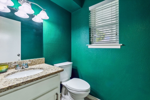 bathroom with toilet and vanity