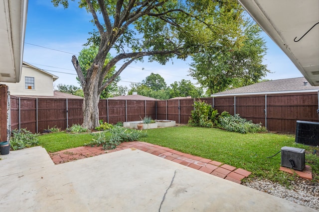 view of yard with central AC unit and a patio