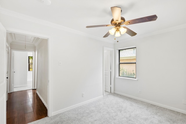 empty room featuring ceiling fan, hardwood / wood-style flooring, and ornamental molding