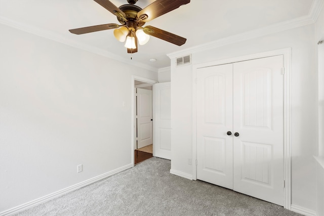 unfurnished bedroom featuring ceiling fan, ornamental molding, a closet, and light carpet