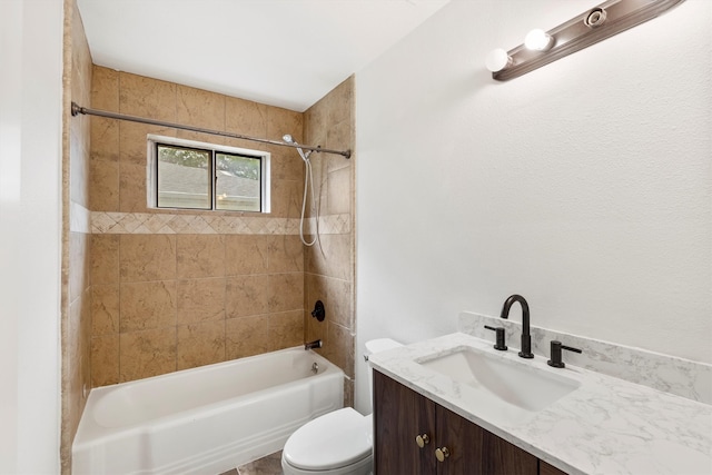 full bathroom featuring tiled shower / bath, toilet, and vanity