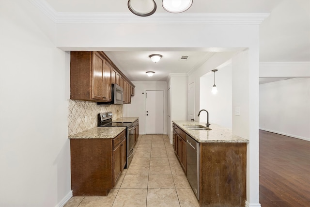 kitchen with crown molding, stainless steel appliances, light stone counters, and sink