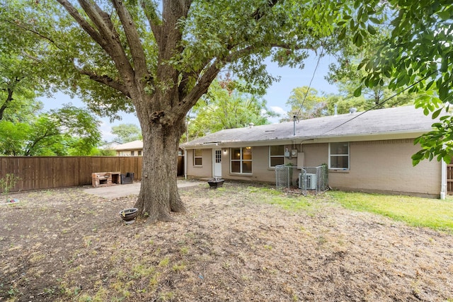 rear view of house featuring central AC unit and a patio