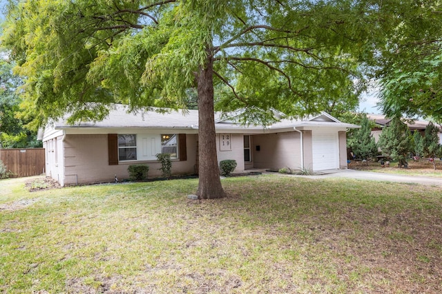 ranch-style home featuring a front lawn and a garage