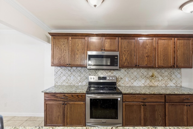 kitchen with stainless steel appliances, light stone countertops, and decorative backsplash