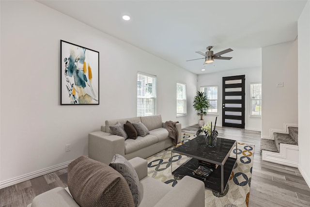 living room featuring light hardwood / wood-style floors and ceiling fan