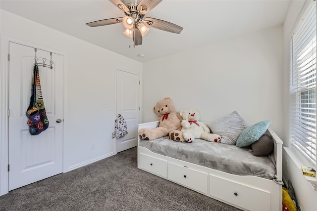 carpeted bedroom featuring ceiling fan and a closet