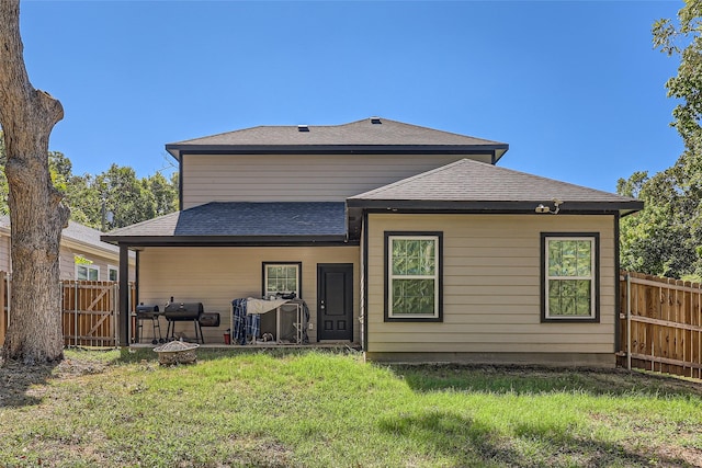 back of property featuring a yard